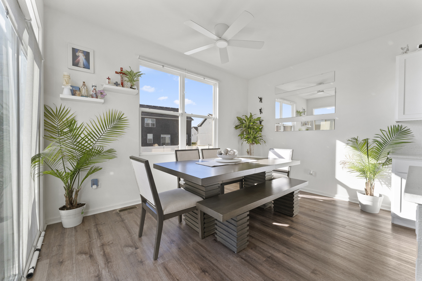 2017 Lilyana Lane Plainfield, IL 60586 - Photo 11 of 43 a dining room with furniture potted plants and wooden floor