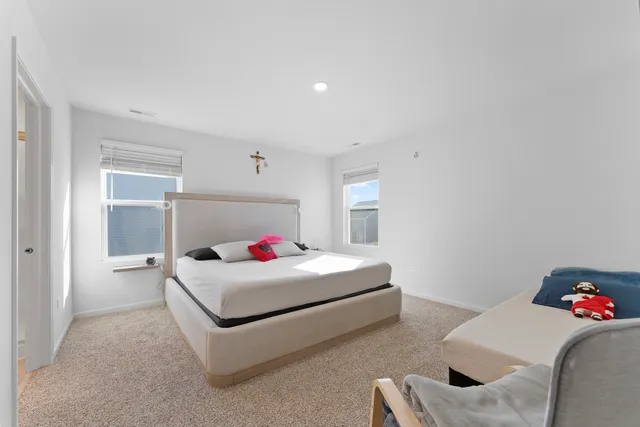 a bedroom with a bed and flat screen tv