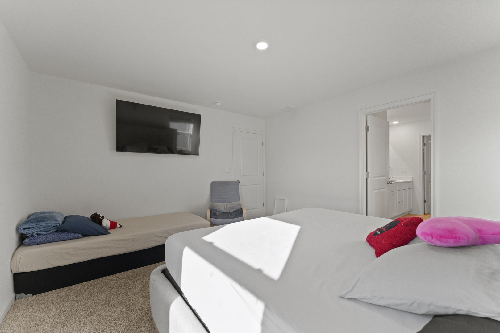 2017 Lilyana Lane Plainfield, IL 60586 - Photo 18 of 43 a bedroom with a bed a flat screen tv and a potted plant