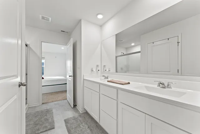 a bedroom with a bed and flat screen tv