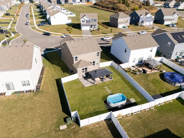 an aerial view of a house with swimming pool