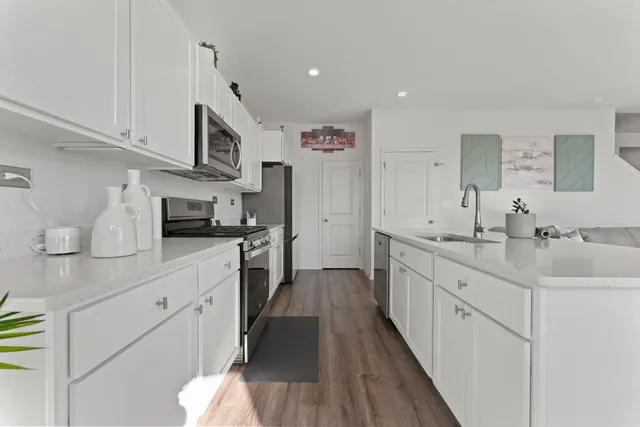 a kitchen with stainless steel appliances kitchen island granite countertop a sink and cabinets