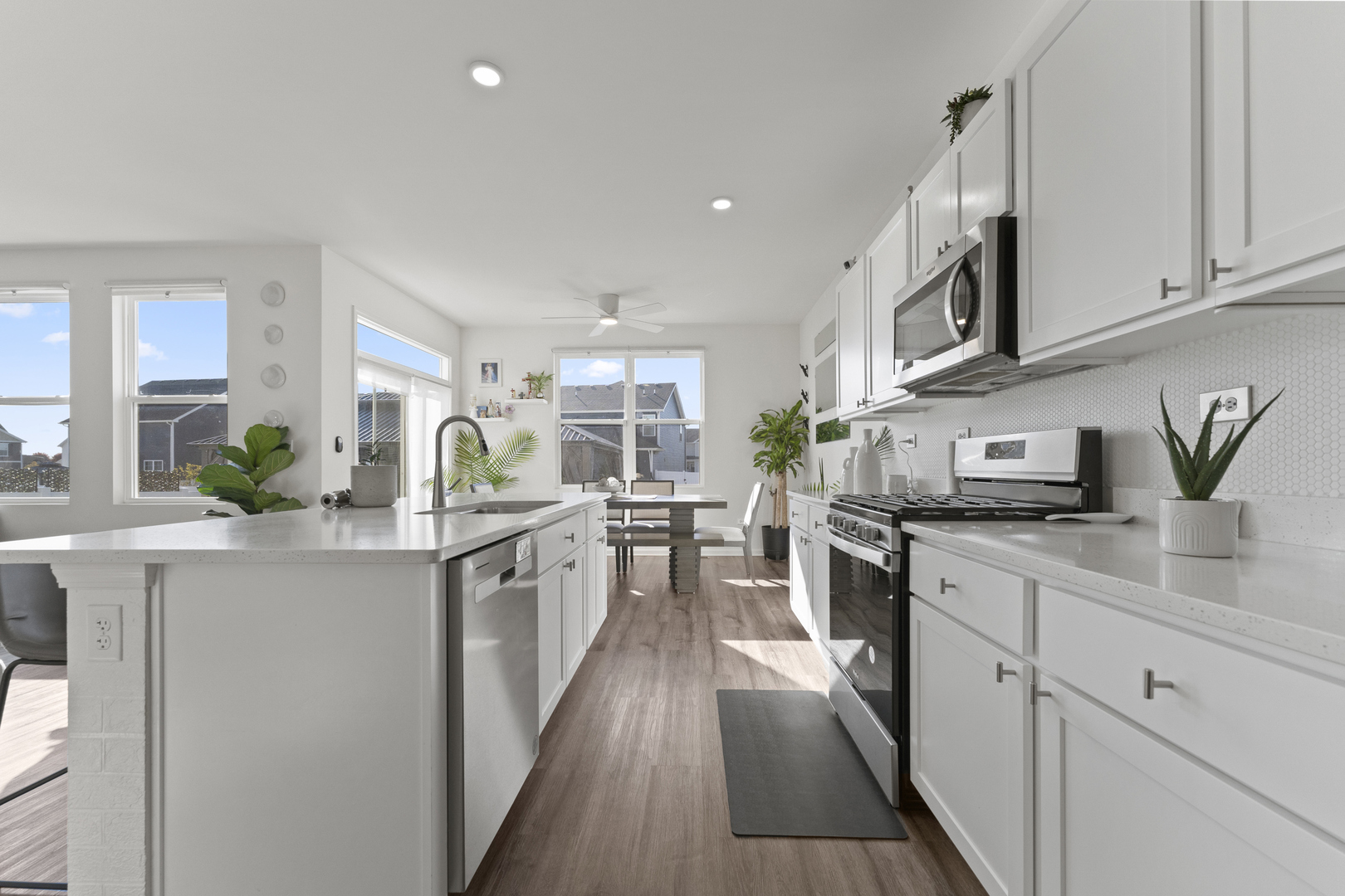 2017 Lilyana Lane Plainfield, IL 60586 - Photo 9 of 43 a kitchen with white cabinets sink and stove
