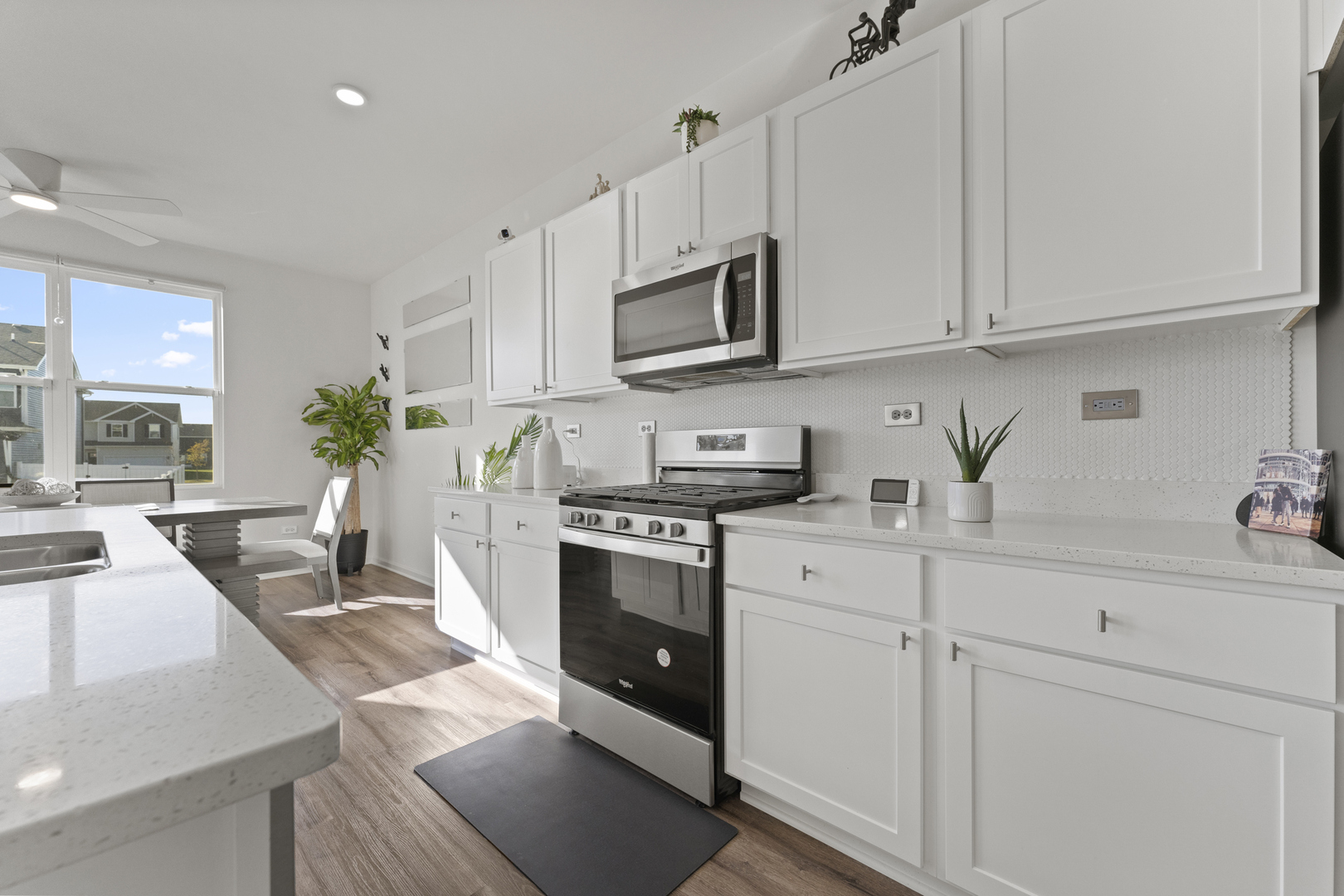 2017 Lilyana Lane Plainfield, IL 60586 - Photo 10 of 43 a kitchen with stainless steel appliances granite countertop white cabinets sink and stove