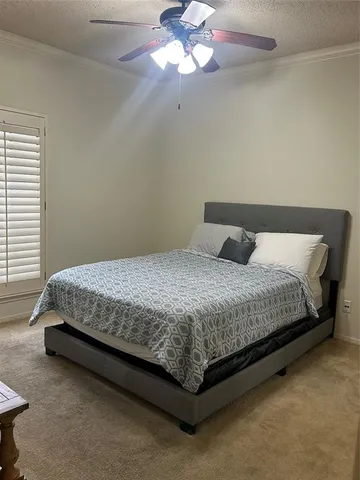 a bedroom with a bed and window