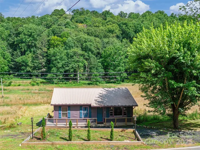 a view of house with garden space and trees