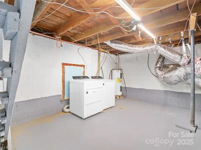 a utility room with a wooden floor washer and dryer