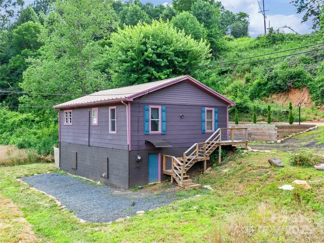 a backyard of a house with table and chairs