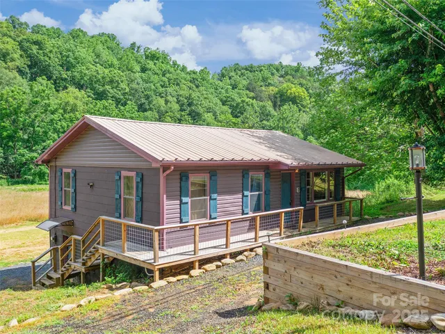 a view of a house with backyard porch and sitting area