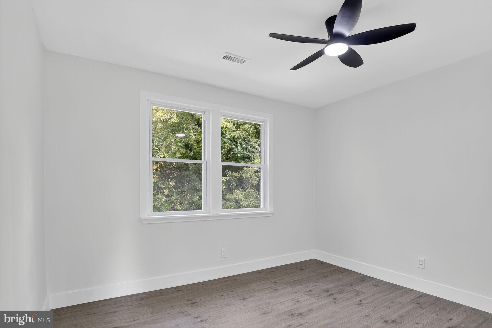 1116 Gleneagle Road, Unit 2 Baltimore, MD 21239 - Photo 11 of 18 an empty room with a window and a fan