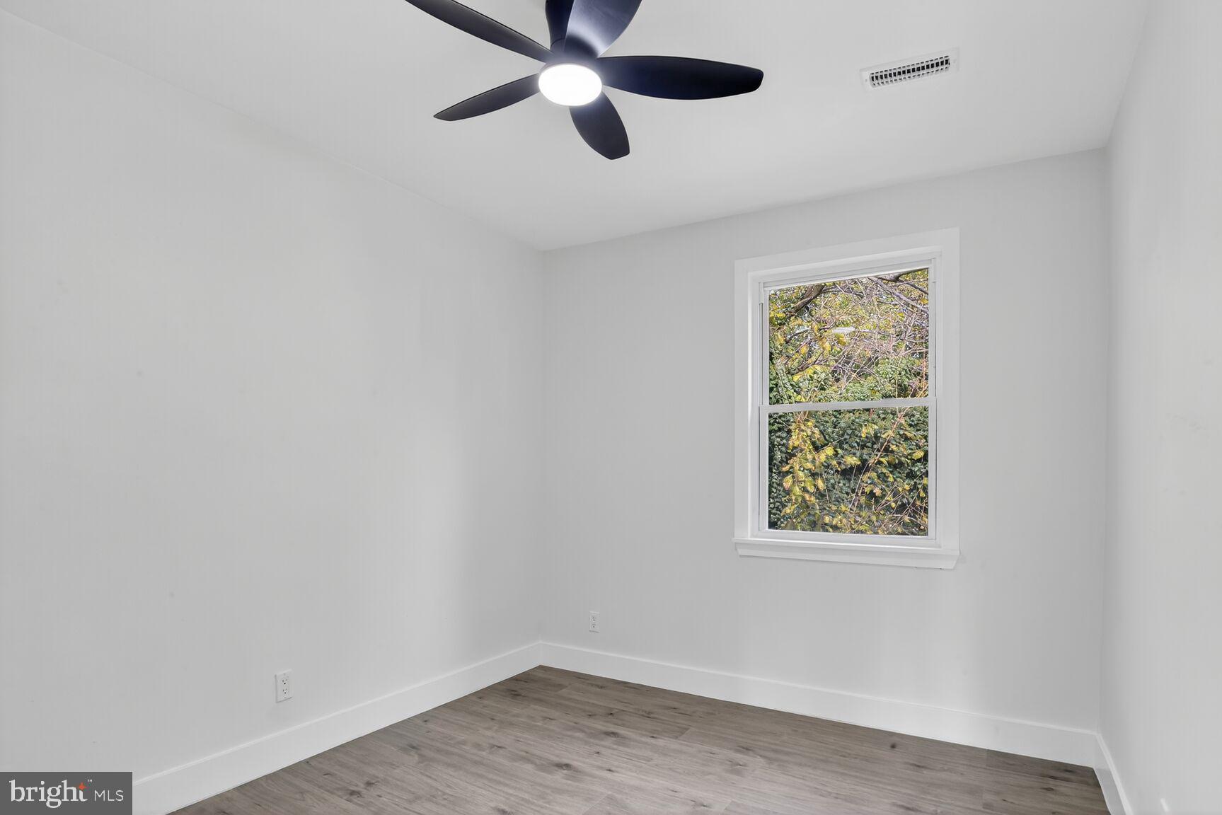 1116 Gleneagle Road, Unit 2 Baltimore, MD 21239 - Photo 12 of 18 an empty room with a window and a ceiling fan