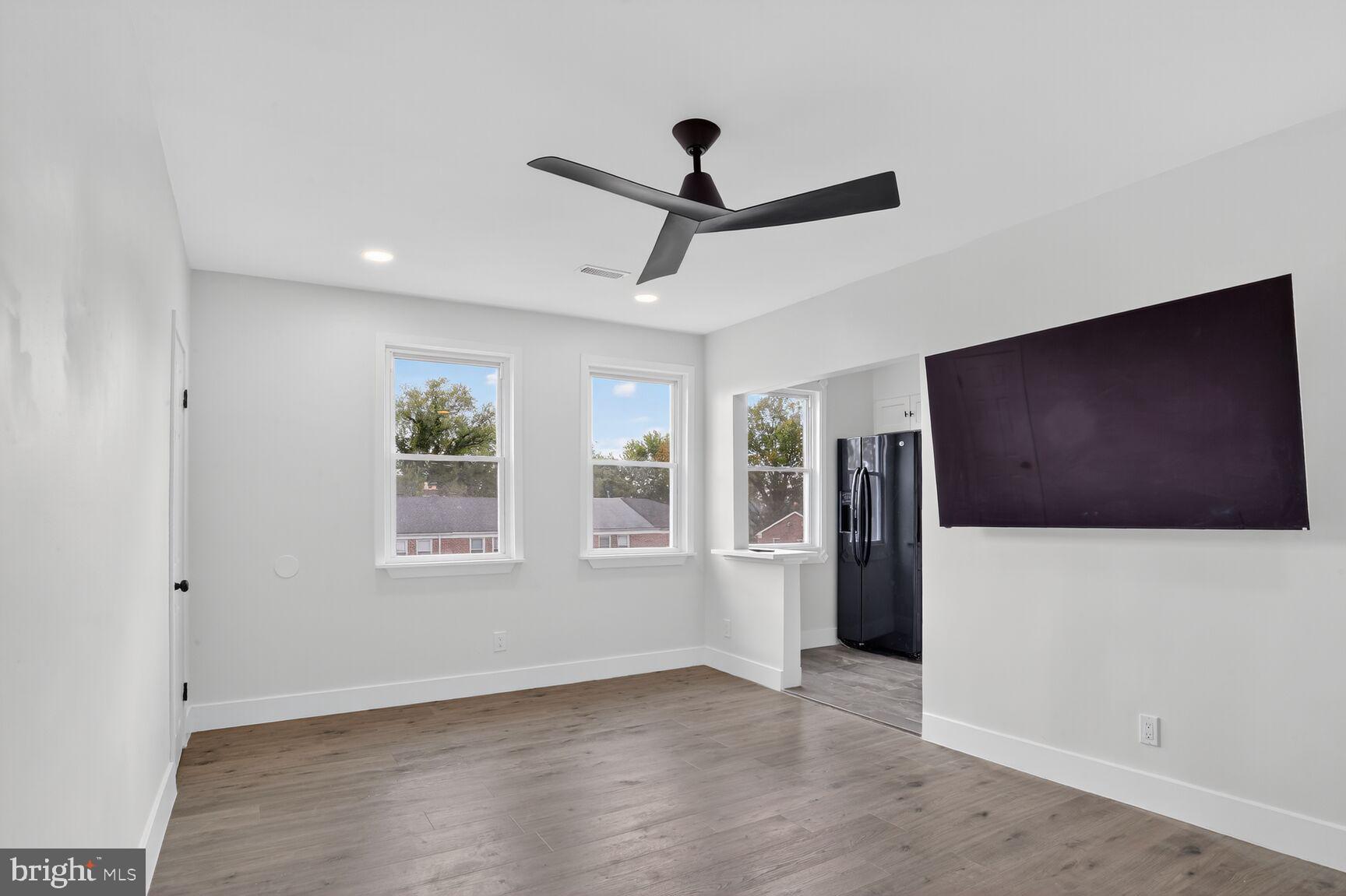 1116 Gleneagle Road, Unit 2 Baltimore, MD 21239 - Photo 6 of 18 a view of livingroom with hardwood floor and a ceiling fan