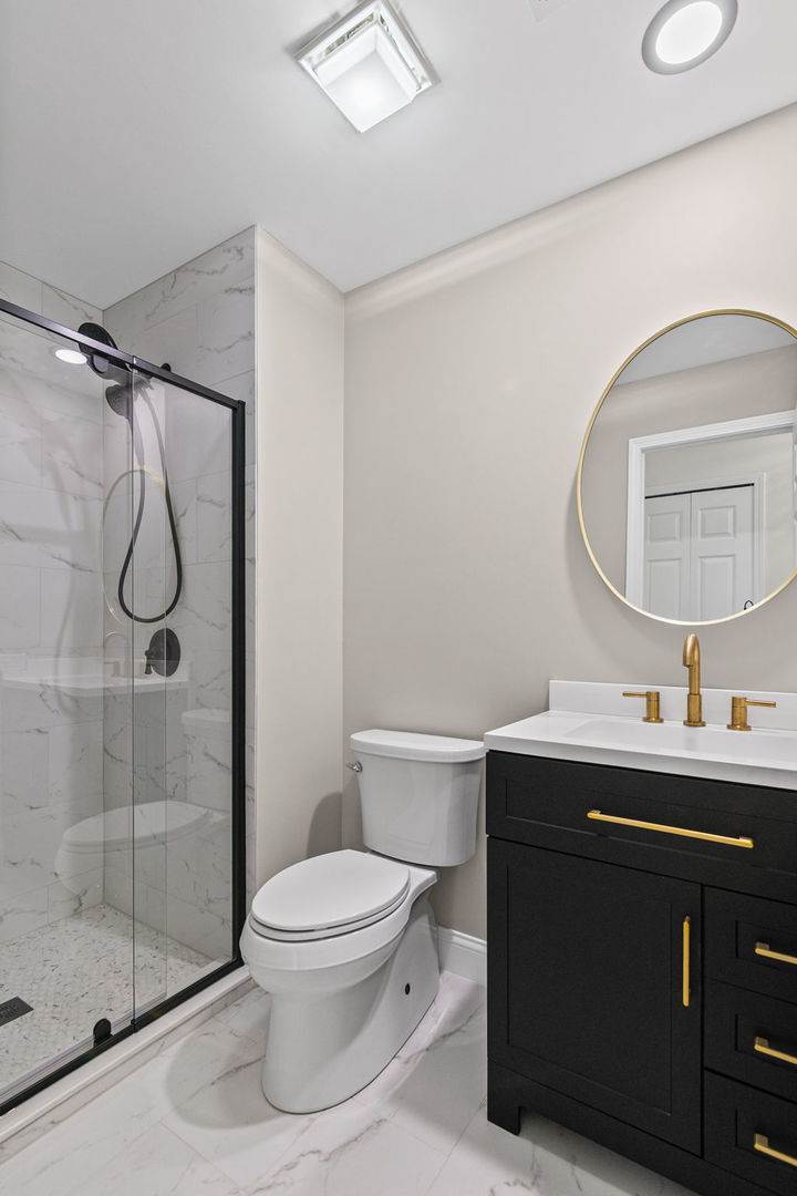 753 Shoreline Road Lake Barrington, IL 60010 - Photo 12 of 21 a bathroom with a sink toilet a mirror and shower