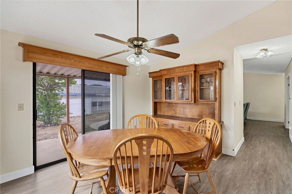 24800 Cornstalk Road Wildomar, CA 92595 - Photo 7 of 23 a dining room with furniture a chandelier and wooden floor