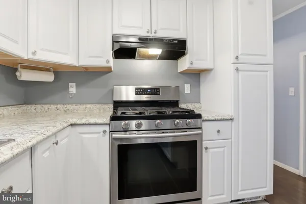 a kitchen with stainless steel appliances granite countertop a stove a microwave and cabinets