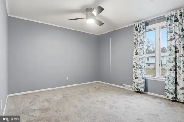 a view of empty room with ceiling fan
