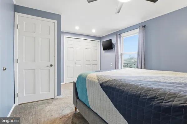 a spacious bedroom with a bed and a window