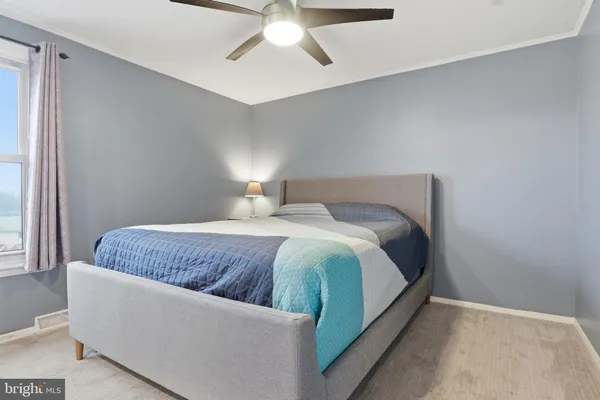 a bedroom with a bed rug and window