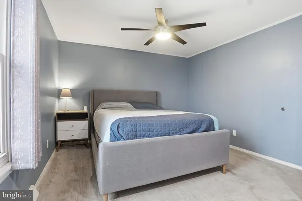 a living room with furniture and a ceiling fan