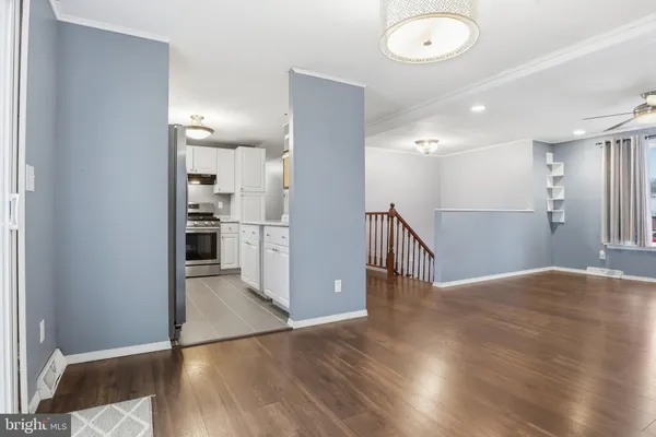 a view of a hallway with wooden floor
