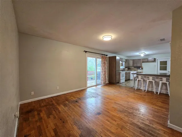 a view of kitchen with furniture and wooden floor