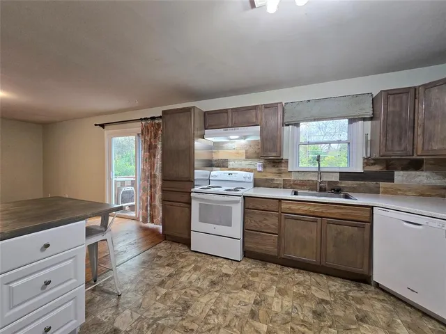 a kitchen with a sink stove and cabinets