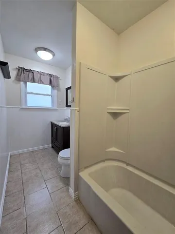 a bathroom with a bathtub sink and toilet
