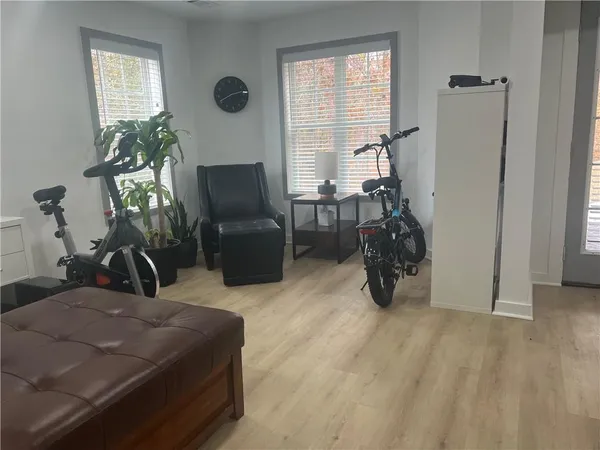 a room with gym equipment and a flat screen tv