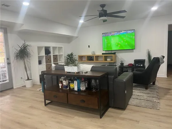 a living room with furniture and a flat screen tv