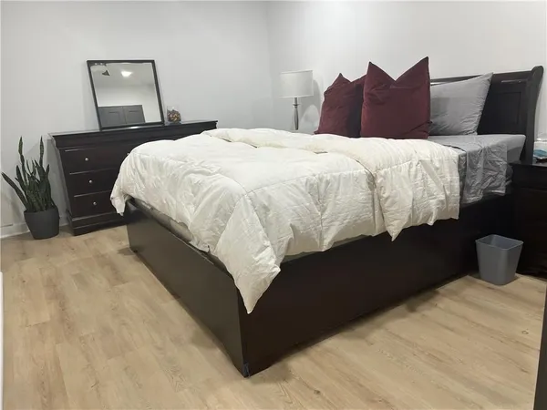 a bedroom with bed and window