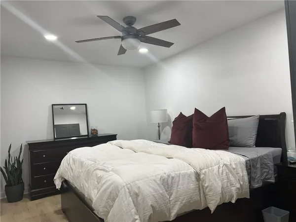 a bedroom with a bed and a lamp