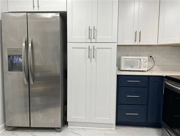 a kitchen with a refrigerator and cabinets
