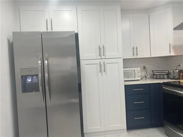 a kitchen with cabinets and stainless steel appliances