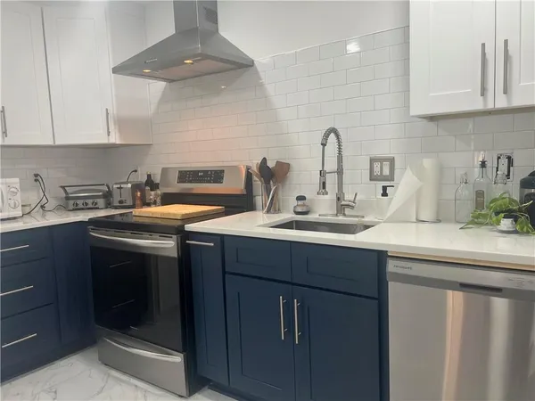 a kitchen with a sink stove and cabinets