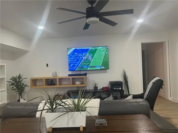 a living room with furniture and a flat screen tv