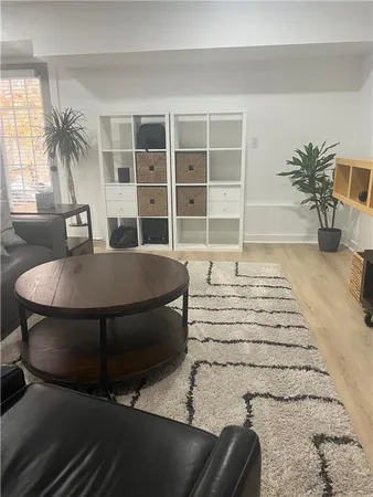 a living room with a couch and a potted plant on the table