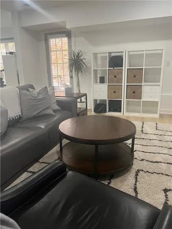 a living room with furniture a window and a table