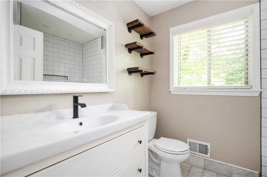 3850 Beya Way Atlanta, GA 30340 - Photo 15 of 18 a bathroom with a sink a toilet and a window