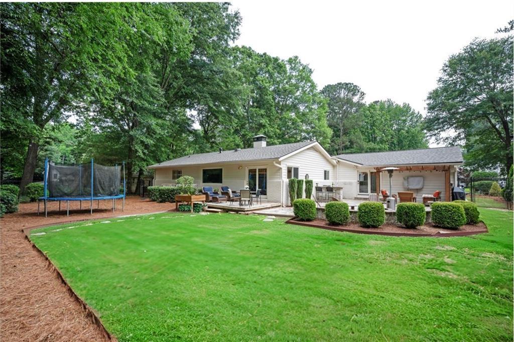 3850 Beya Way Atlanta, GA 30340 - Photo 17 of 18 a front view of house with yard and outdoor seating
