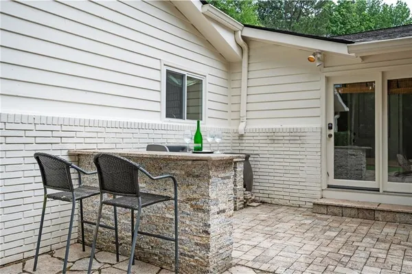 a view of a patio with table and chairs and wooden floor