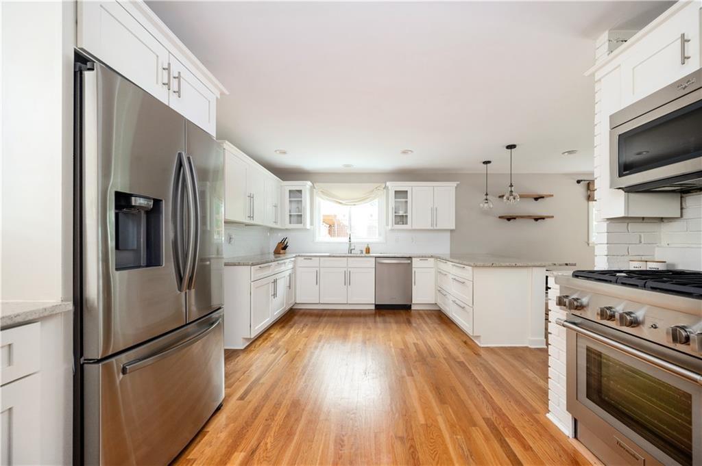 3850 Beya Way Atlanta, GA 30340 - Photo 2 of 18 a kitchen with stainless steel appliances a refrigerator a stove top oven a sink and cabinets