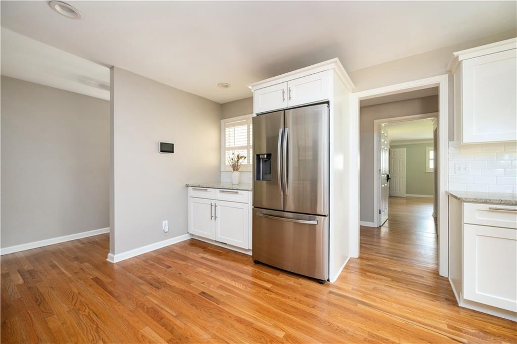 3850 Beya Way Atlanta, GA 30340 - Photo 4 of 18 a kitchen with wooden floor and refrigerator