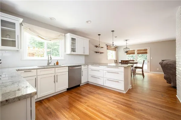 a kitchen with white cabinets and white appliances
