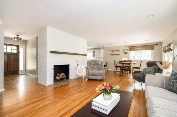 a living room with furniture fireplace and a table