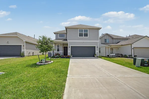a front view of house with yard and green space