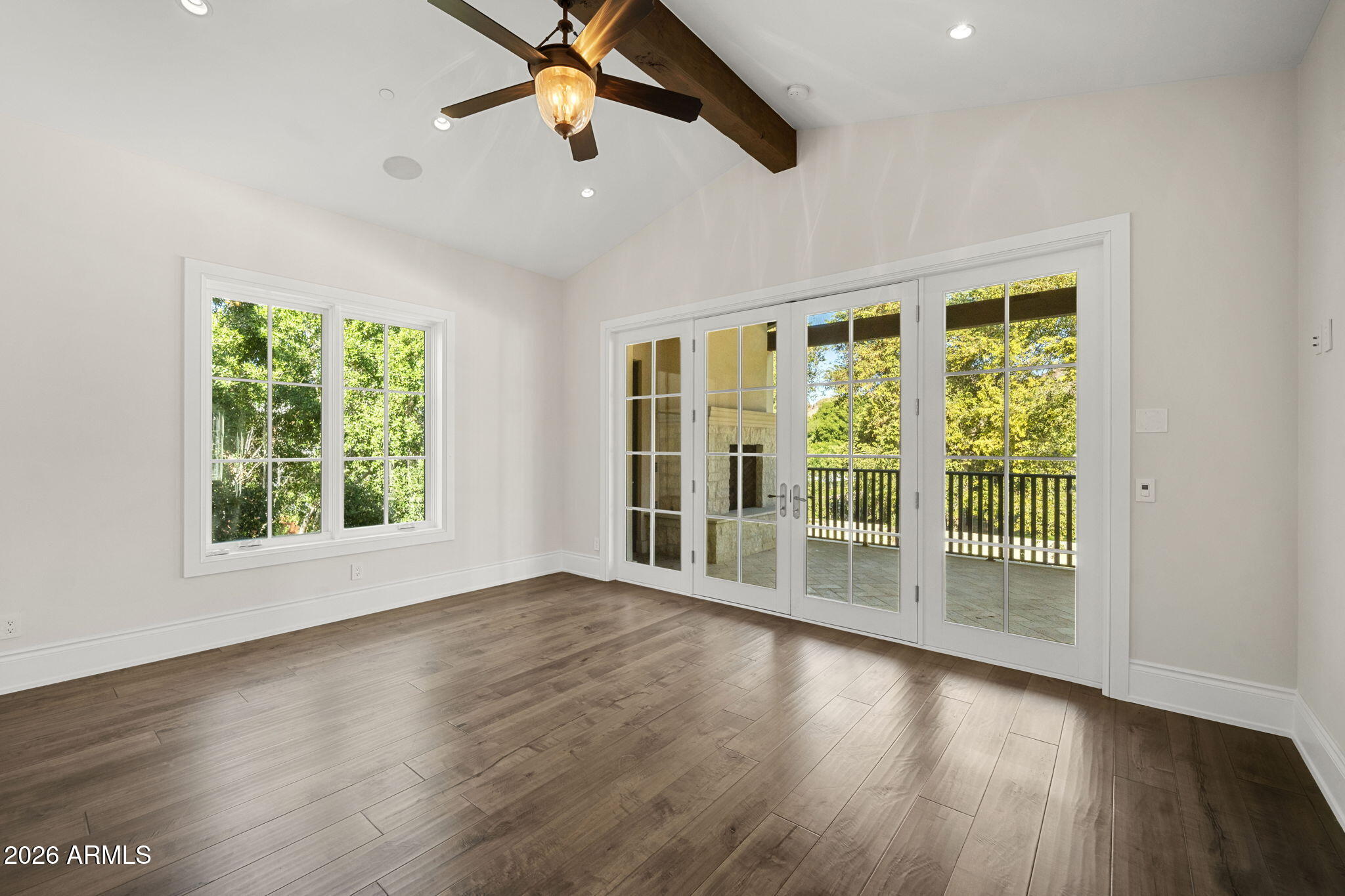 5402 East Exeter Boulevard Phoenix, AZ 85018 - Photo 61 of 110 a view of an empty room with wooden floor and a window