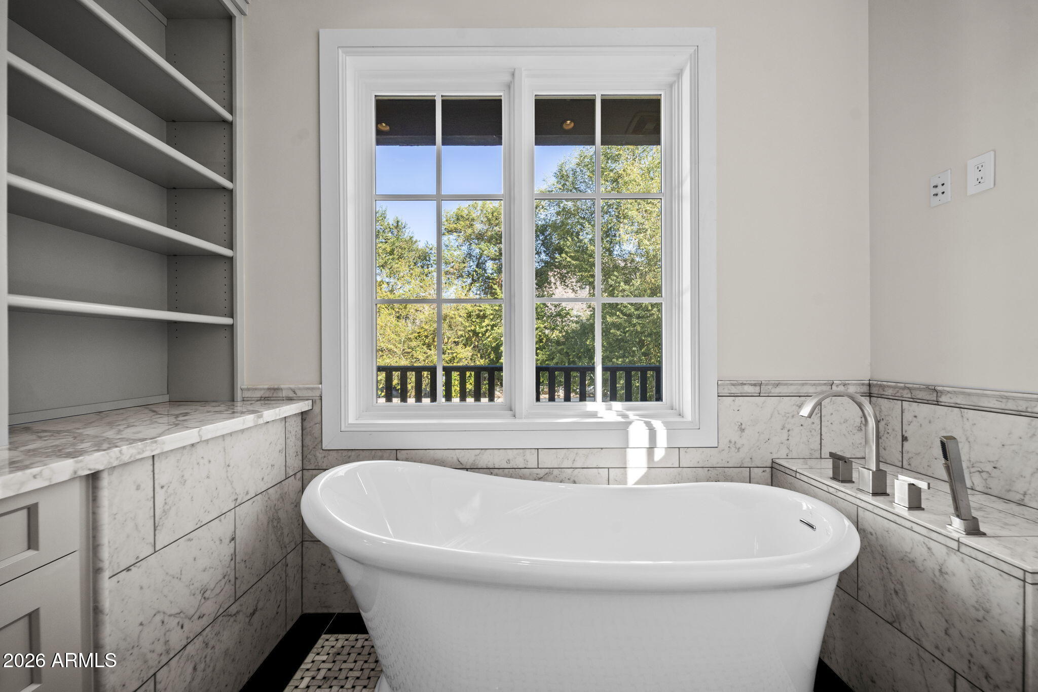 5402 East Exeter Boulevard Phoenix, AZ 85018 - Photo 75 of 110 a white bath tub sitting in a bathroom next to a window