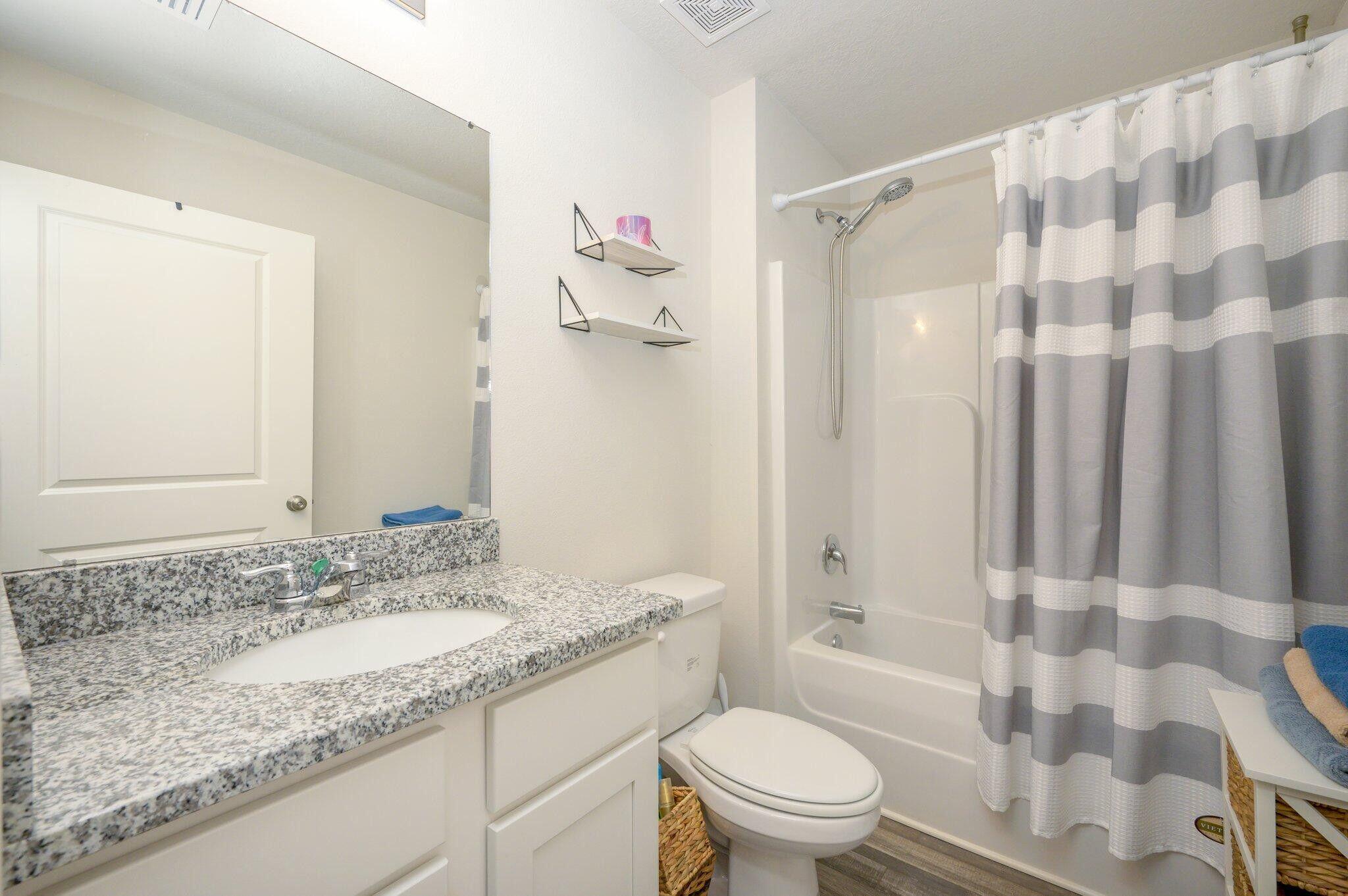 42 Lockwood Way East DeFuniak Springs, FL 32435 - Photo 19 of 39 a bathroom with a granite countertop sink toilet and shower