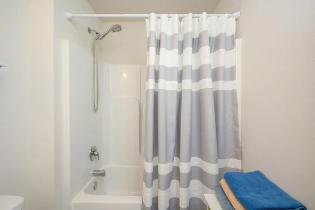 a bathroom with a shower and a toilet