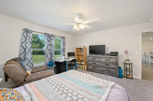 a bedroom with a bed and a television